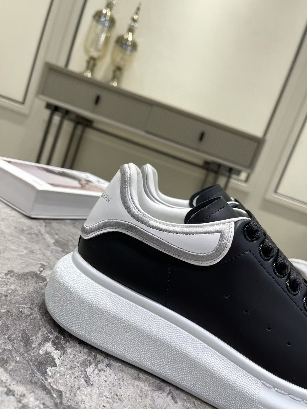 OVERSIZED SNEAKER IN BLACK CALFSKIN WITH SILVER STITCHED WHITE HEEL TAB