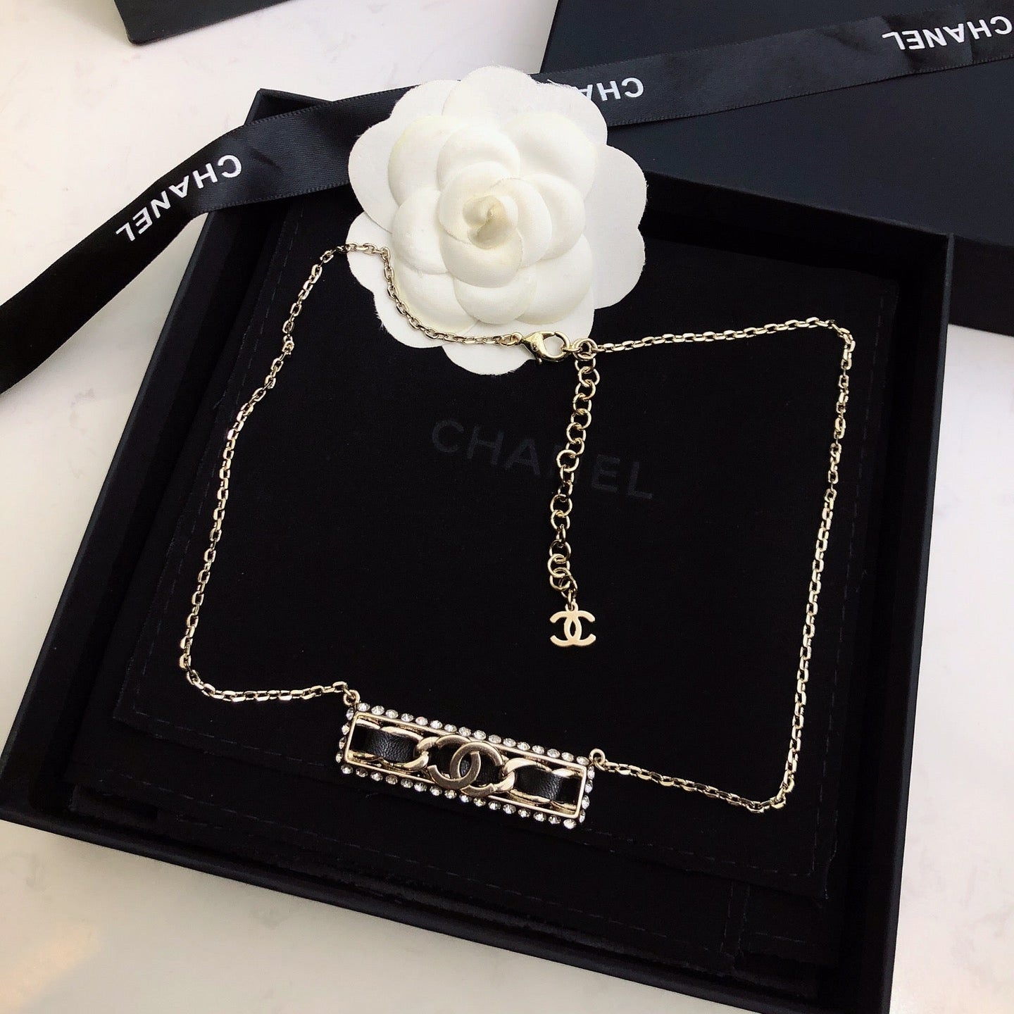 CHANEL 26S CHANEL CC LOGO CRYSTAL TRIM BAR PENDANT NECKLACE WITH BLACK LEATHER IN GOLD METAL 633315
