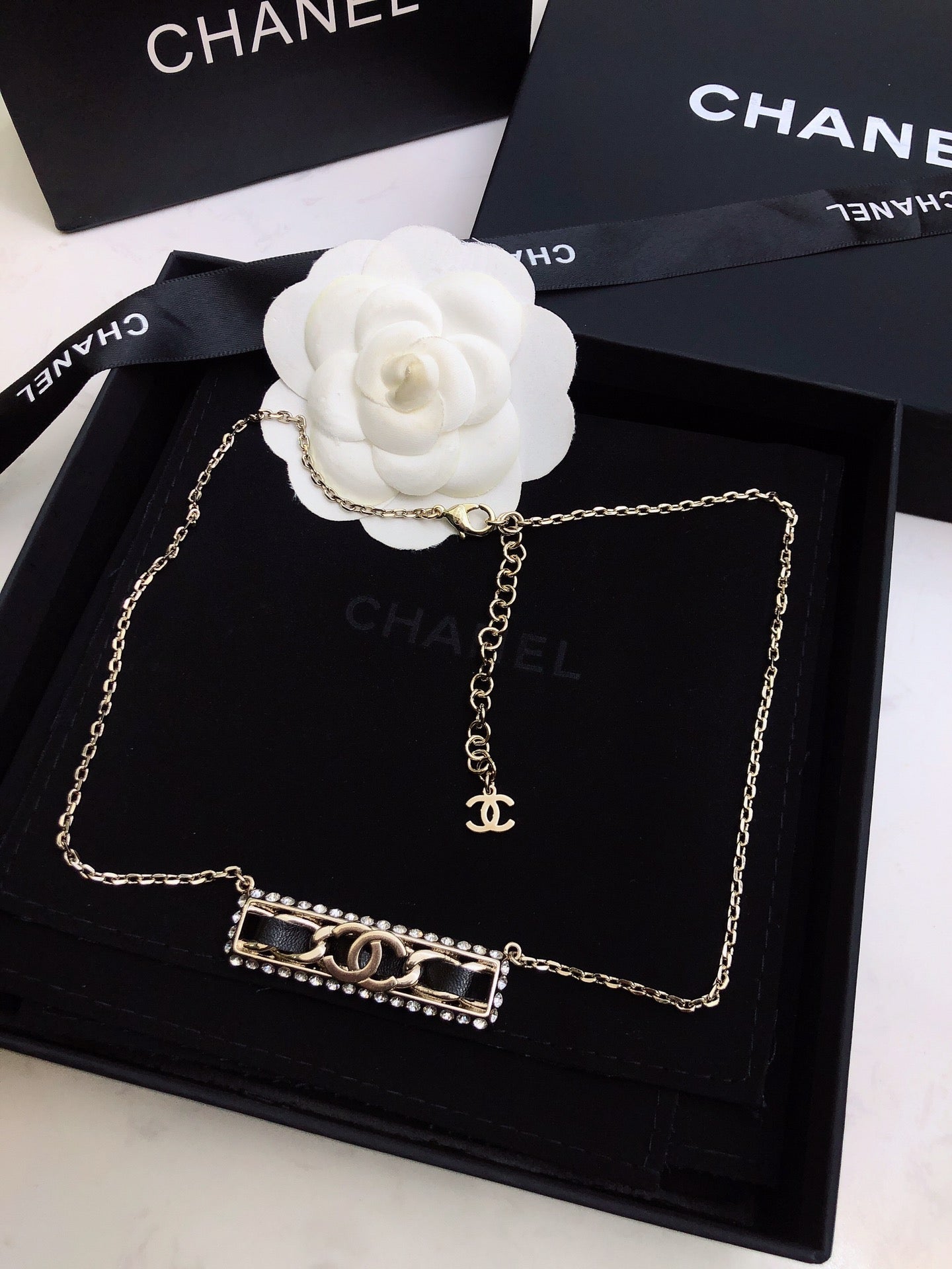 CHANEL 26S CHANEL CC LOGO CRYSTAL TRIM BAR PENDANT NECKLACE WITH BLACK LEATHER IN GOLD METAL 633315