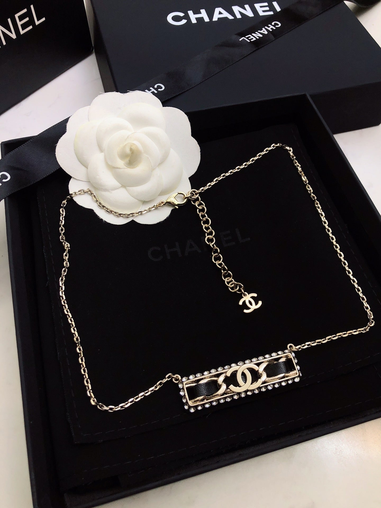 CHANEL 26S CHANEL CC LOGO CRYSTAL TRIM BAR PENDANT NECKLACE WITH BLACK LEATHER IN GOLD METAL 633315