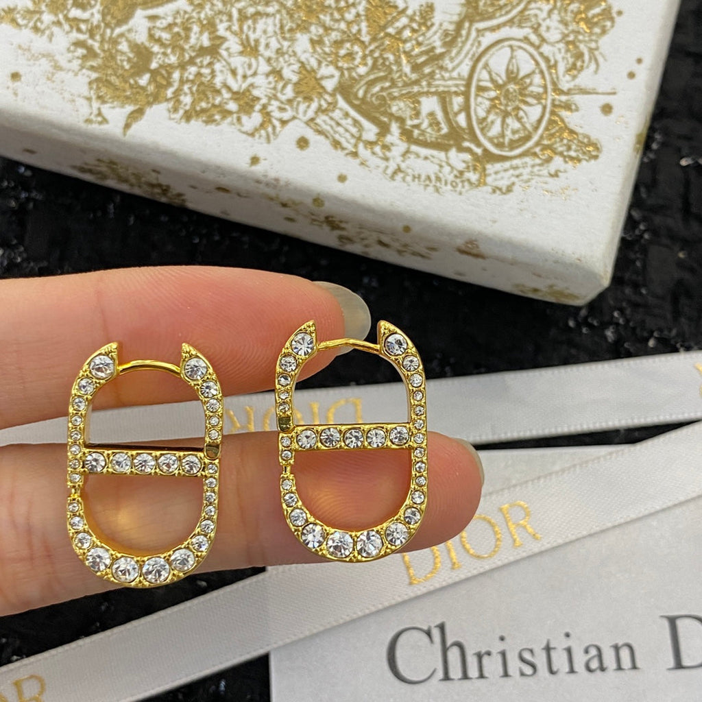 CD 26S CRYSTAL LOGO STUD EARRINGS IN GOLD TONE METAL 646502