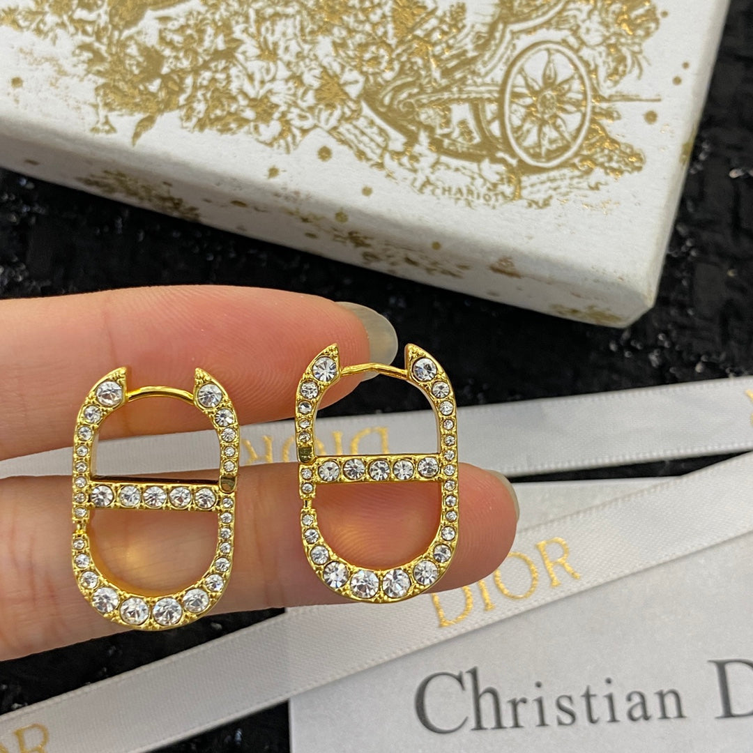 CD 26S CRYSTAL LOGO STUD EARRINGS IN GOLD TONE METAL 646502