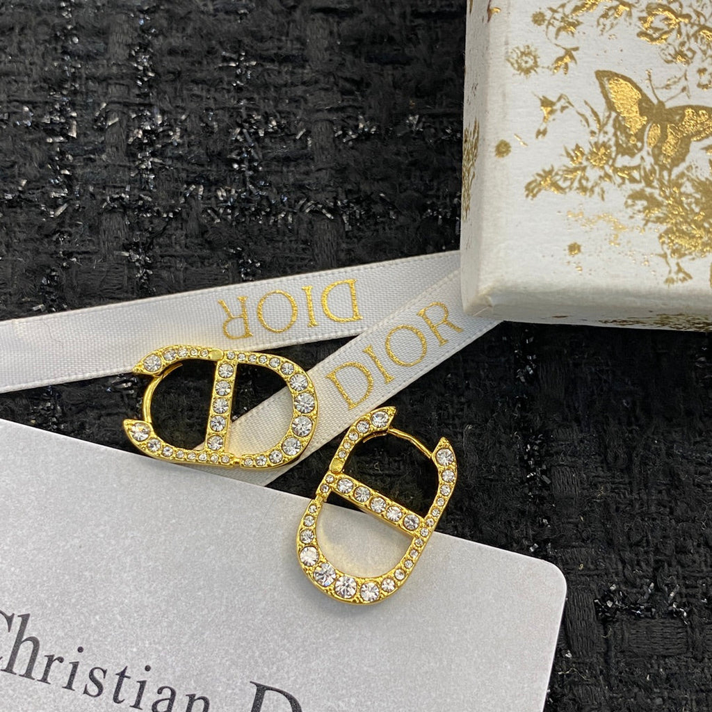 CD 26S CRYSTAL LOGO STUD EARRINGS IN GOLD TONE METAL 646502
