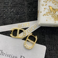 CD 26S CRYSTAL LOGO STUD EARRINGS IN GOLD TONE METAL 646502