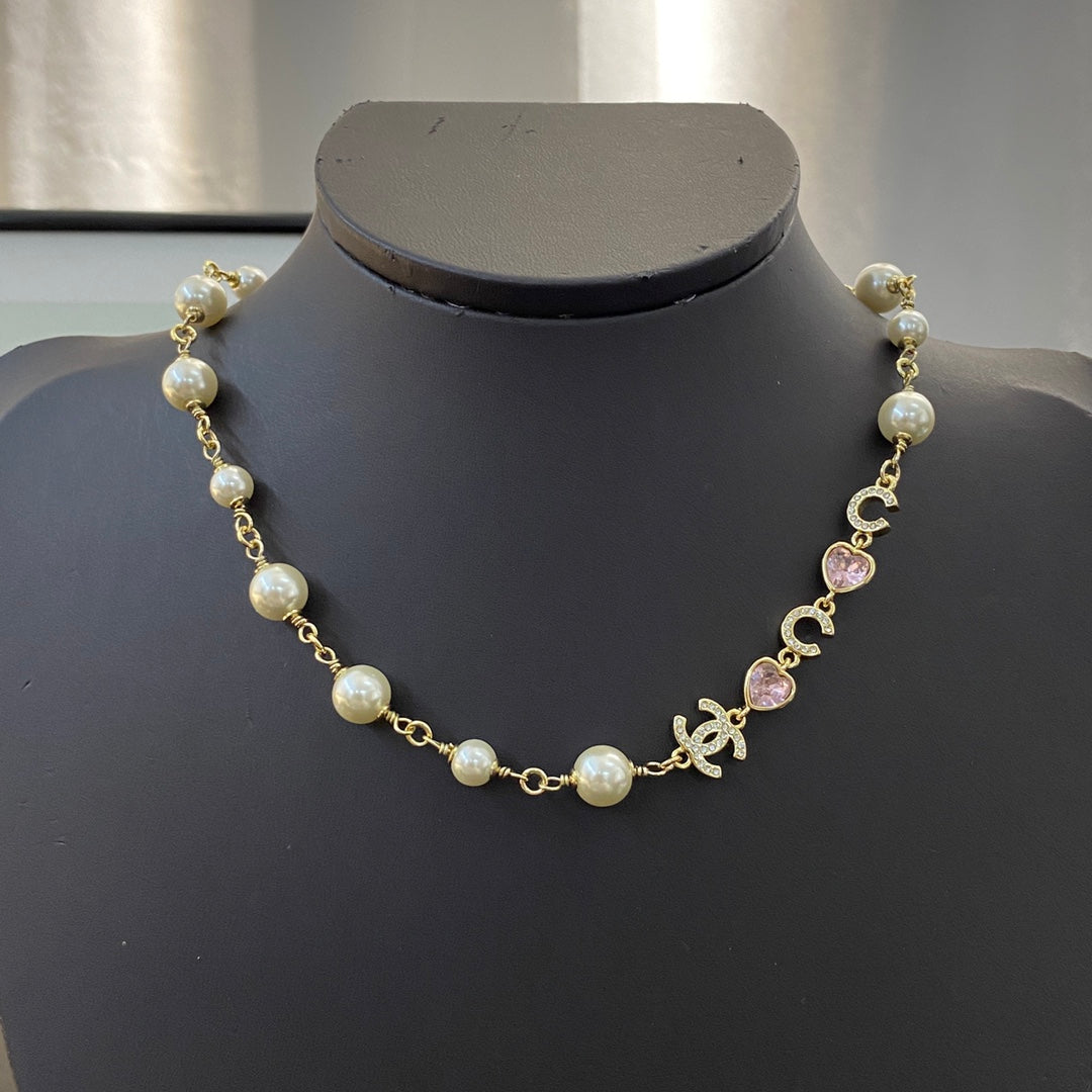 CHANEL 26S DOUBLE C LETTER PEARL NECKLACE WITH HEART CHARMS IN GOLD METAL 631850