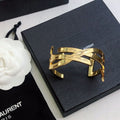 YSL 26S CRISS CROSS OPEN CUFF BRACELET IN GOLD TONE METAL 635064