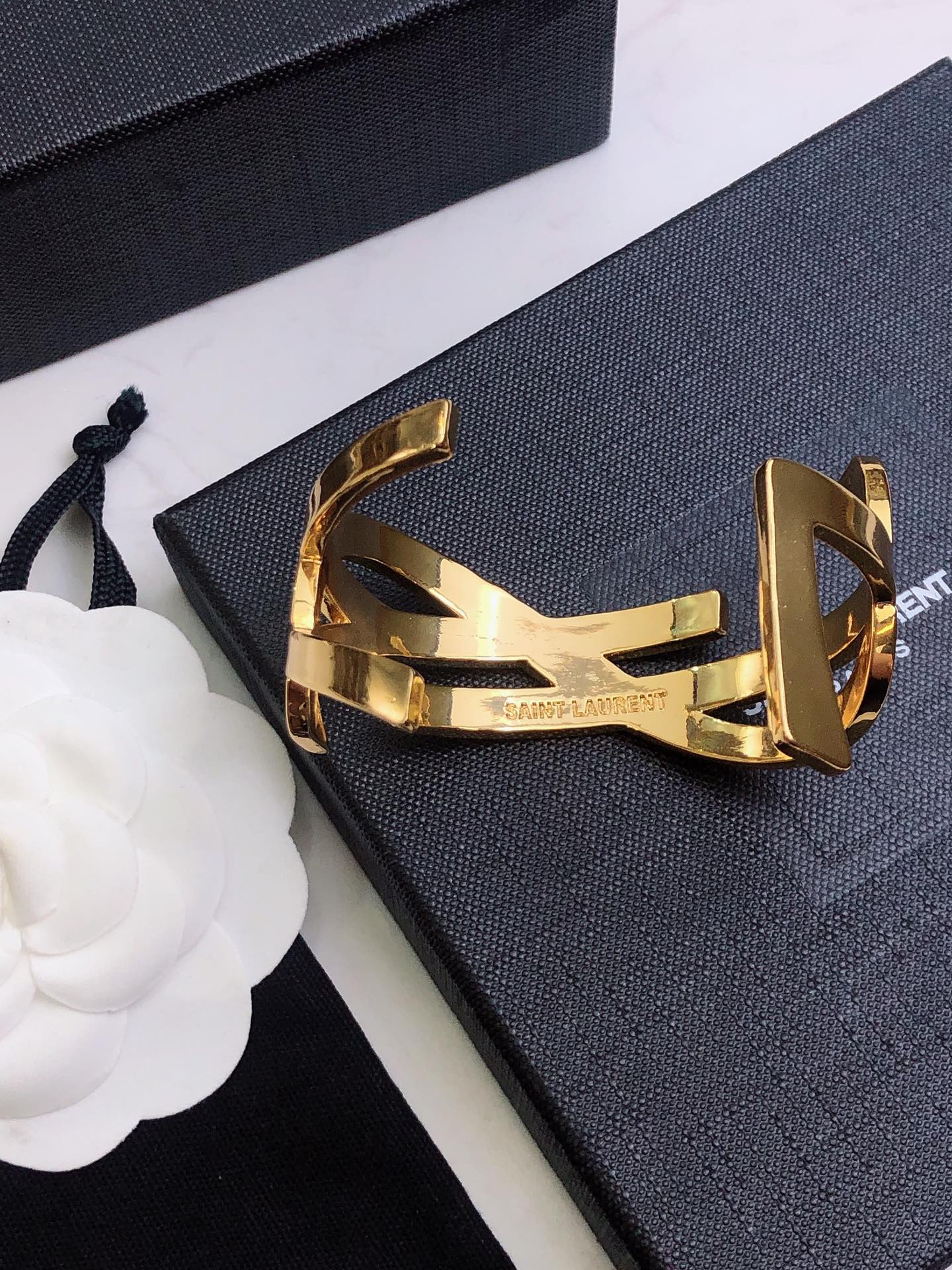 YSL 26S CRISS CROSS OPEN CUFF BRACELET IN GOLD TONE METAL 635064