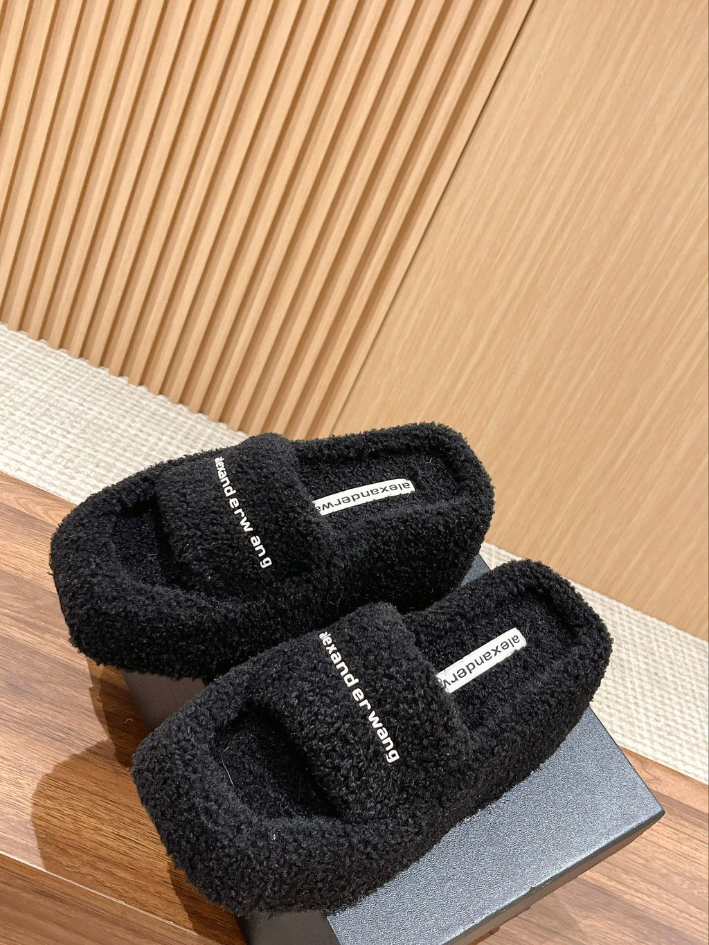 CHUNKY PLATFORM SIPPERS IN BLACK LAMBSWOOL
