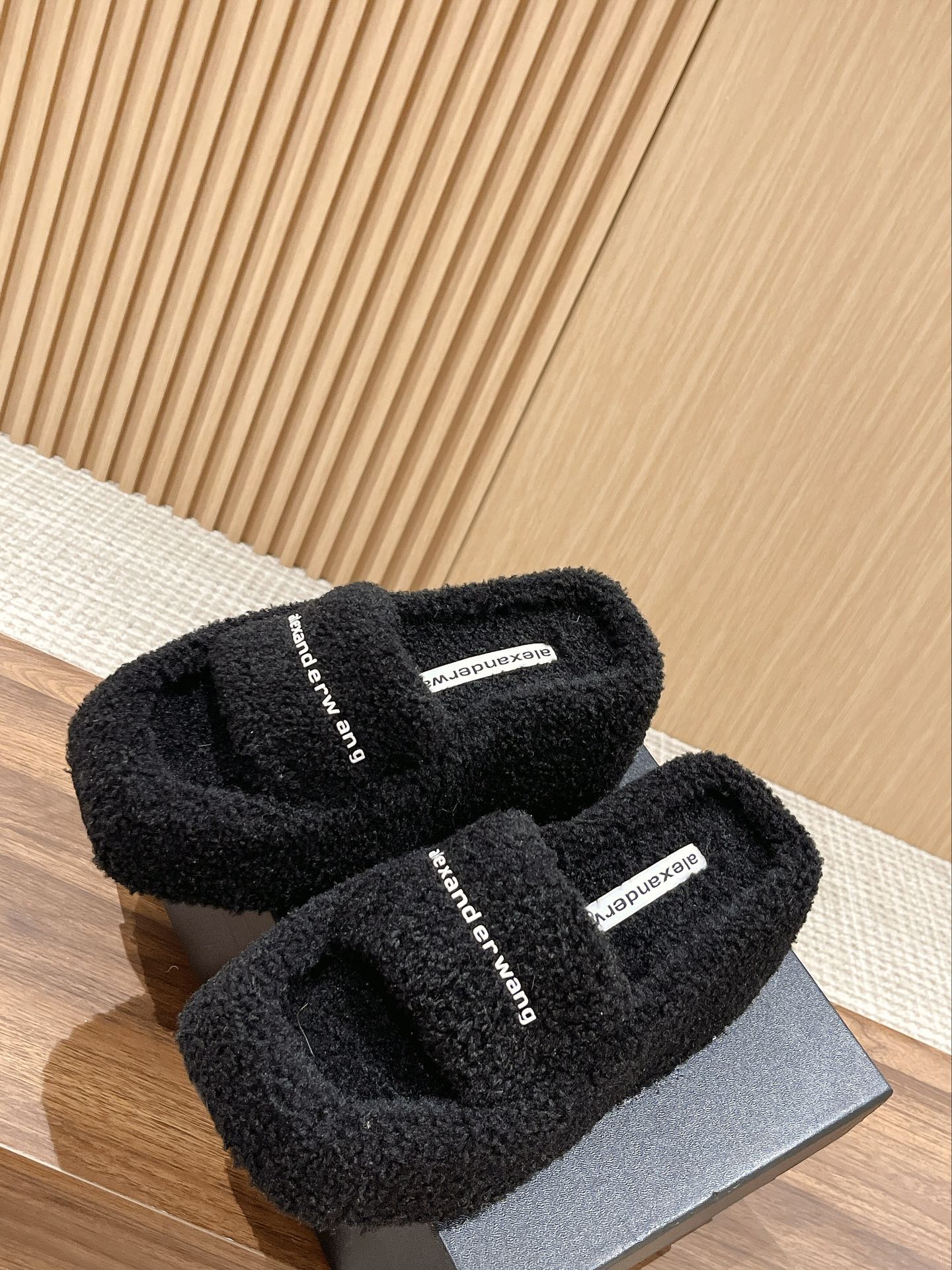 CHUNKY PLATFORM SIPPERS IN BLACK LAMBSWOOL