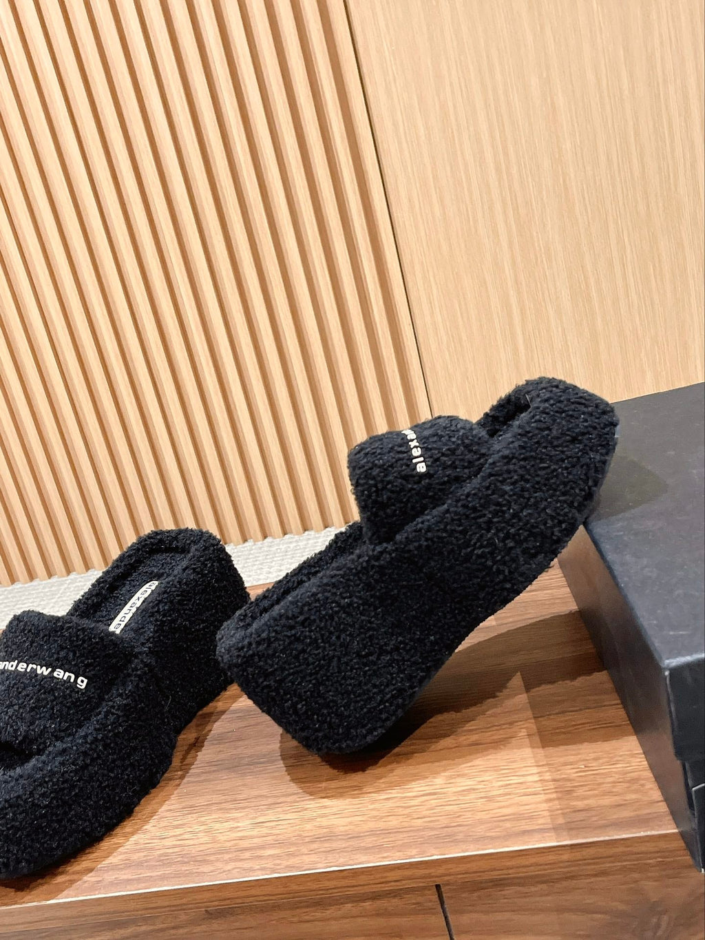 CHUNKY PLATFORM SIPPERS IN BLACK LAMBSWOOL