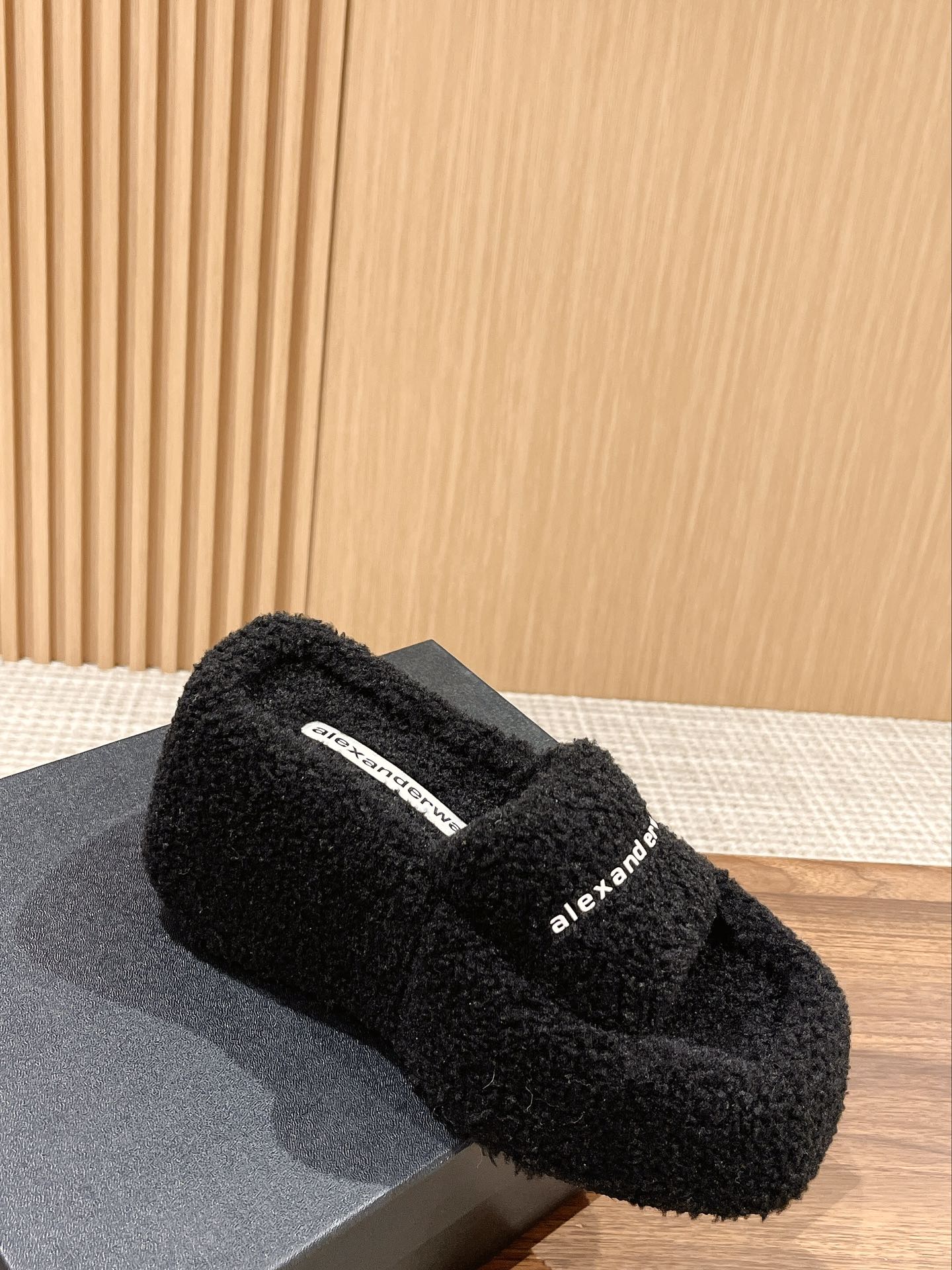 CHUNKY PLATFORM SIPPERS IN BLACK LAMBSWOOL