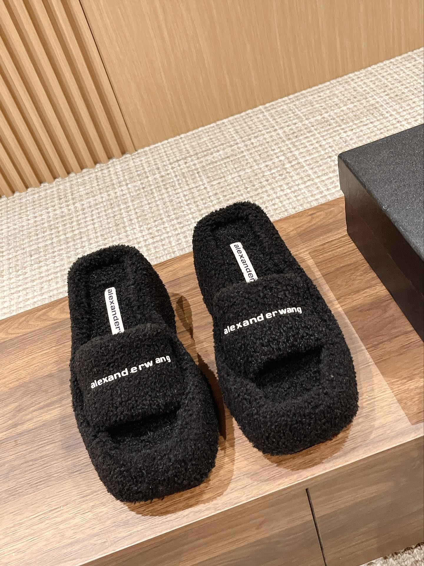 CHUNKY PLATFORM SIPPERS IN BLACK LAMBSWOOL