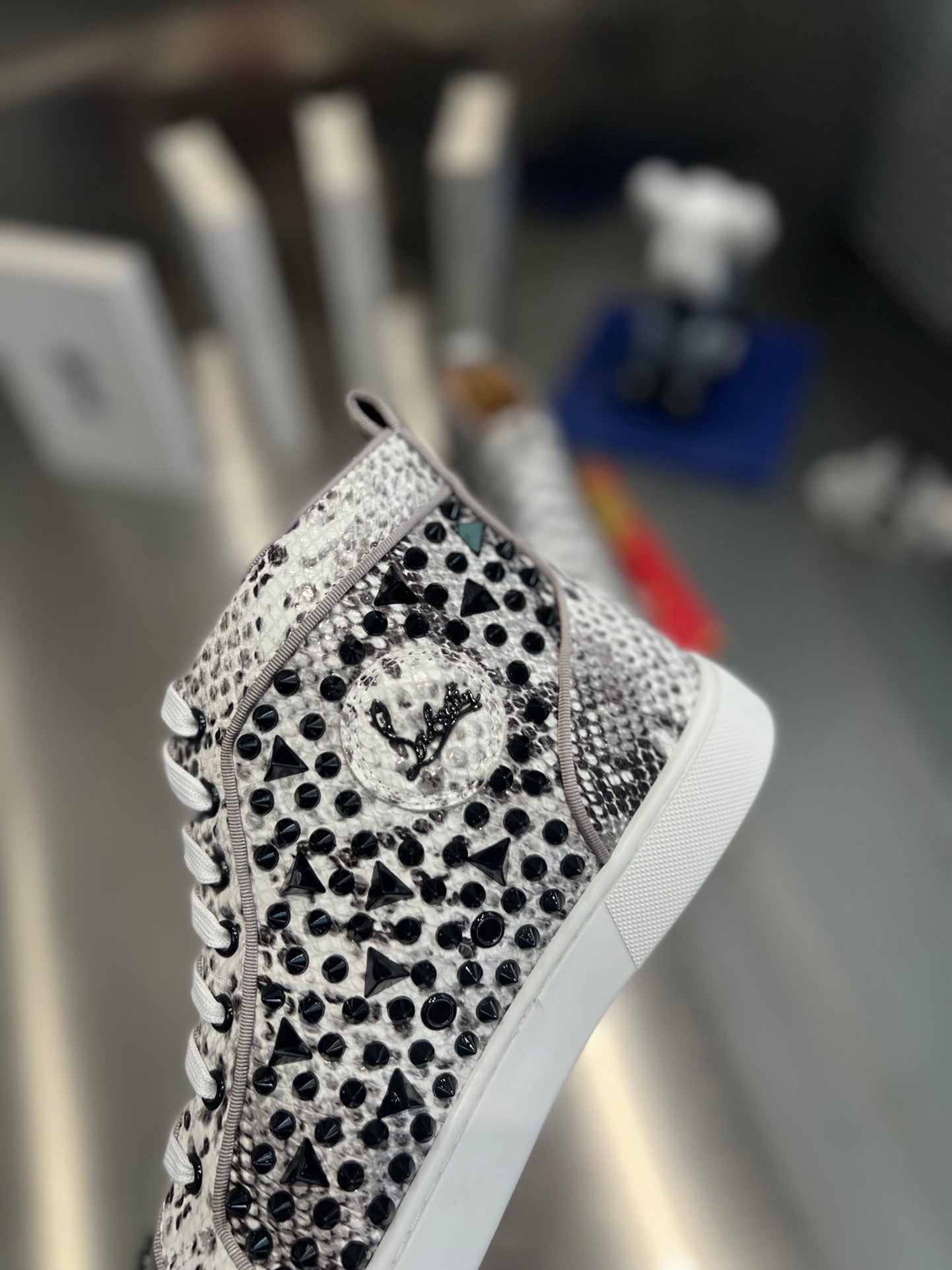 SPIKE STUDDED HIGH-TOP SNEAKERS IN WHITE MIX BLACK CALFSKIN