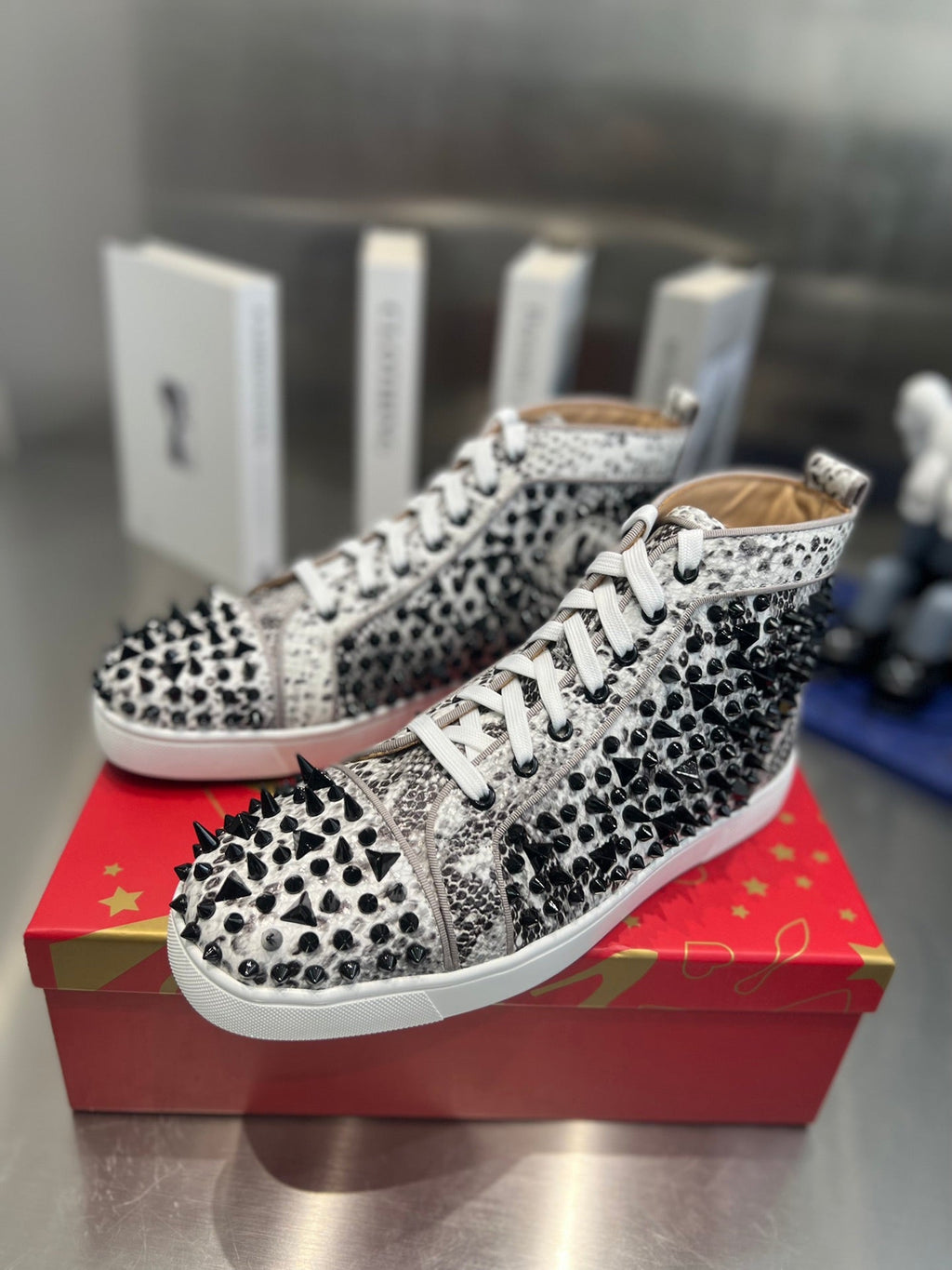 SPIKE STUDDED HIGH-TOP SNEAKERS IN WHITE MIX BLACK CALFSKIN
