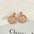 CD 26S CRYSTAL CIRCLE LOGO DROP EARRINGS IN ROSE GOLD TONE METAL 644468