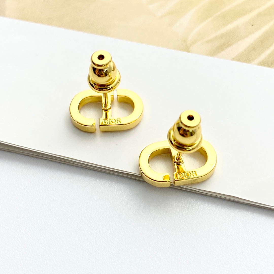 CD 26S CRYSTAL LOGO STUD EARRINGS IN GOLD METAL 633106