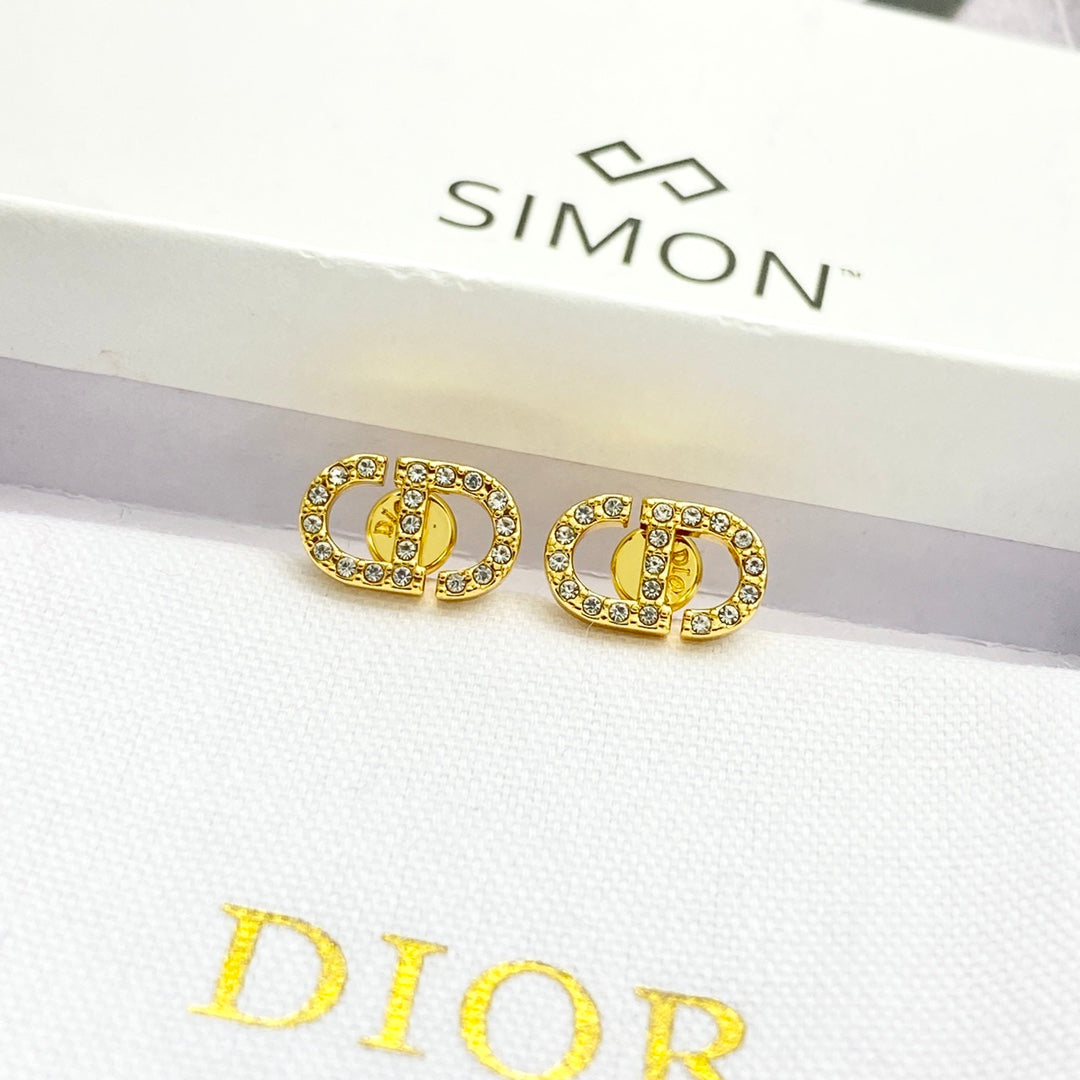 CD 26S CRYSTAL LOGO STUD EARRINGS IN GOLD METAL 633106