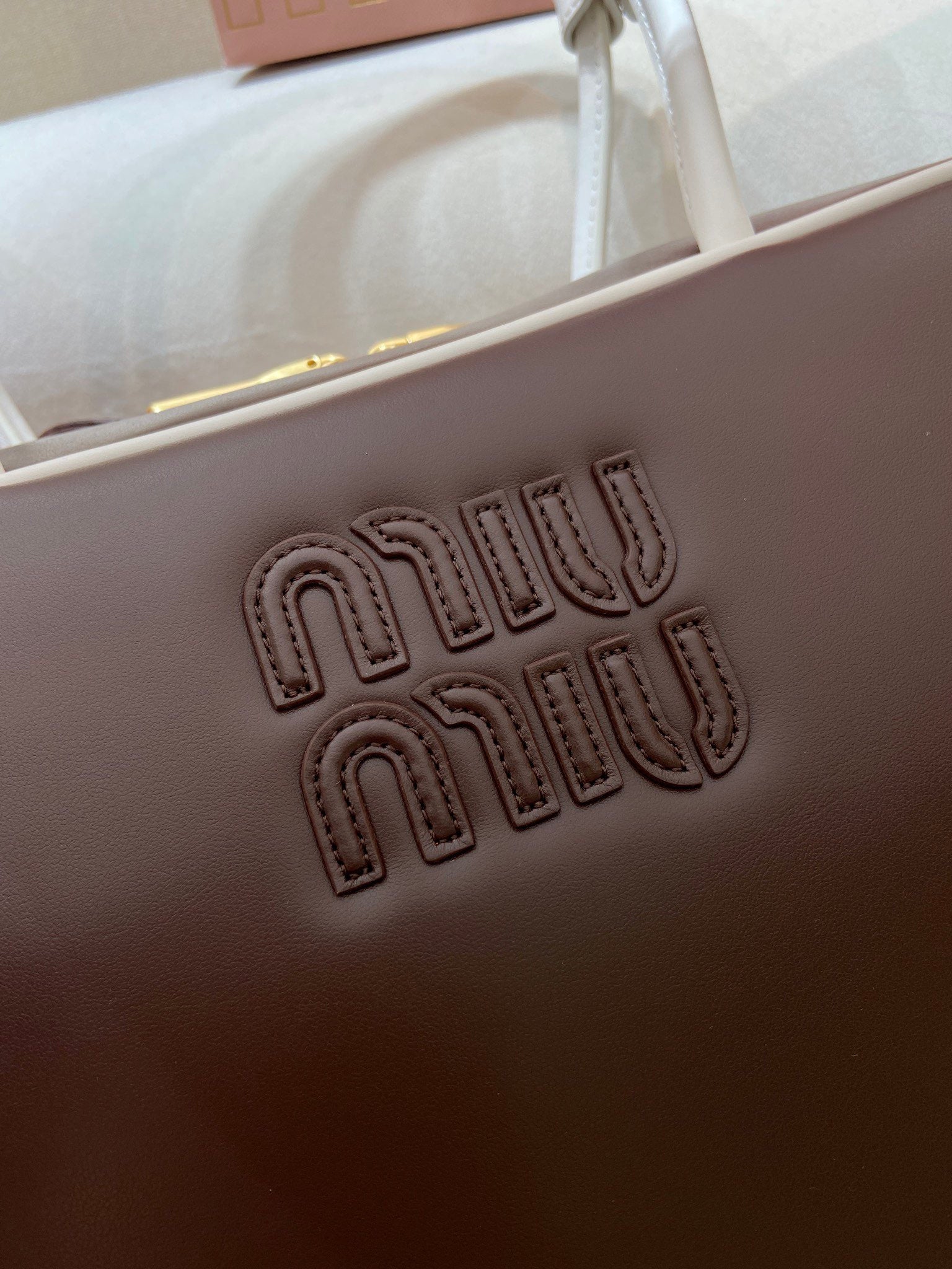 MIUMIU 26S BEAU BAG 34 IN DARK BROWN AND WHITE CALFSKIN