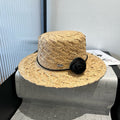 MIUMIU STRAW HAT IN BEIGE RAFFIA WITH BLACK FLOWER ACCENT