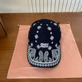 MIUMIU BASEBALL CAP IN BLACK WITH WHITE EMBROIDERED PATTERN