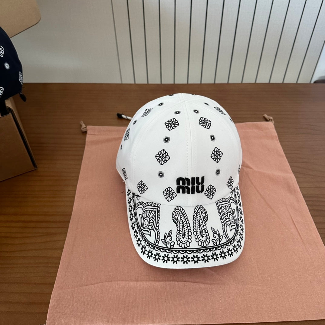 MIUMIU BASEBALL CAP IN WHITE WITH BLACK EMBROIDERED PATTERN