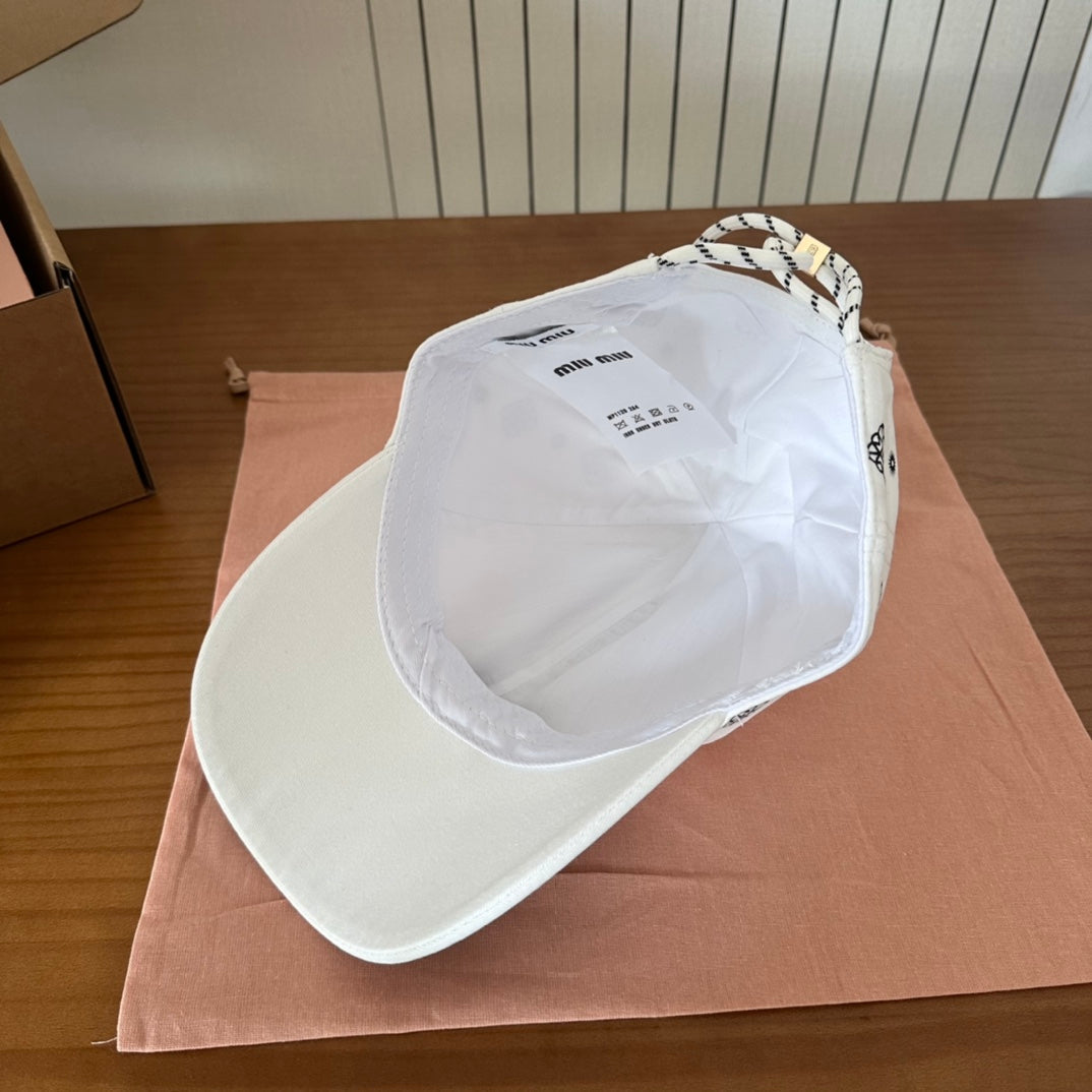 MIUMIU BASEBALL CAP IN WHITE WITH BLACK EMBROIDERED PATTERN