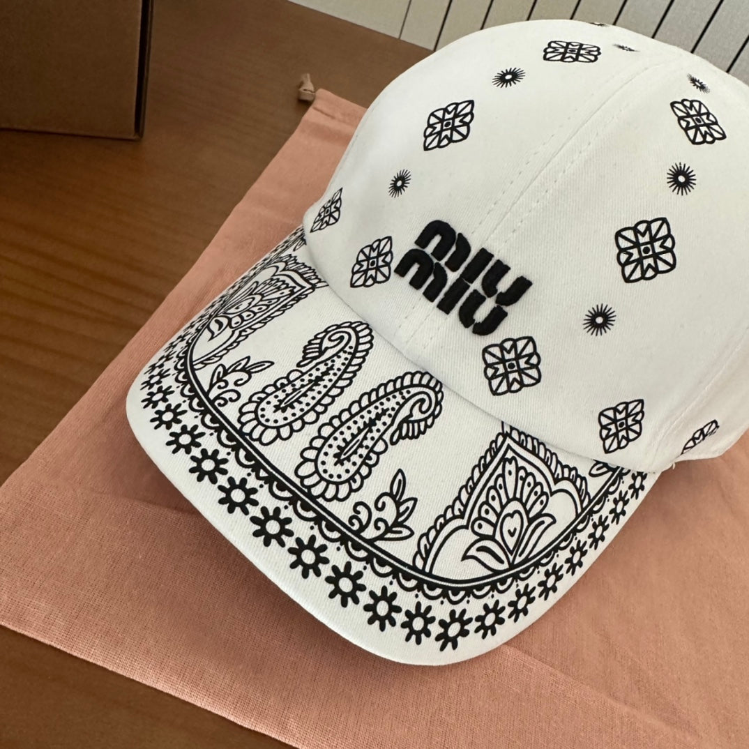 MIUMIU BASEBALL CAP IN WHITE WITH BLACK EMBROIDERED PATTERN