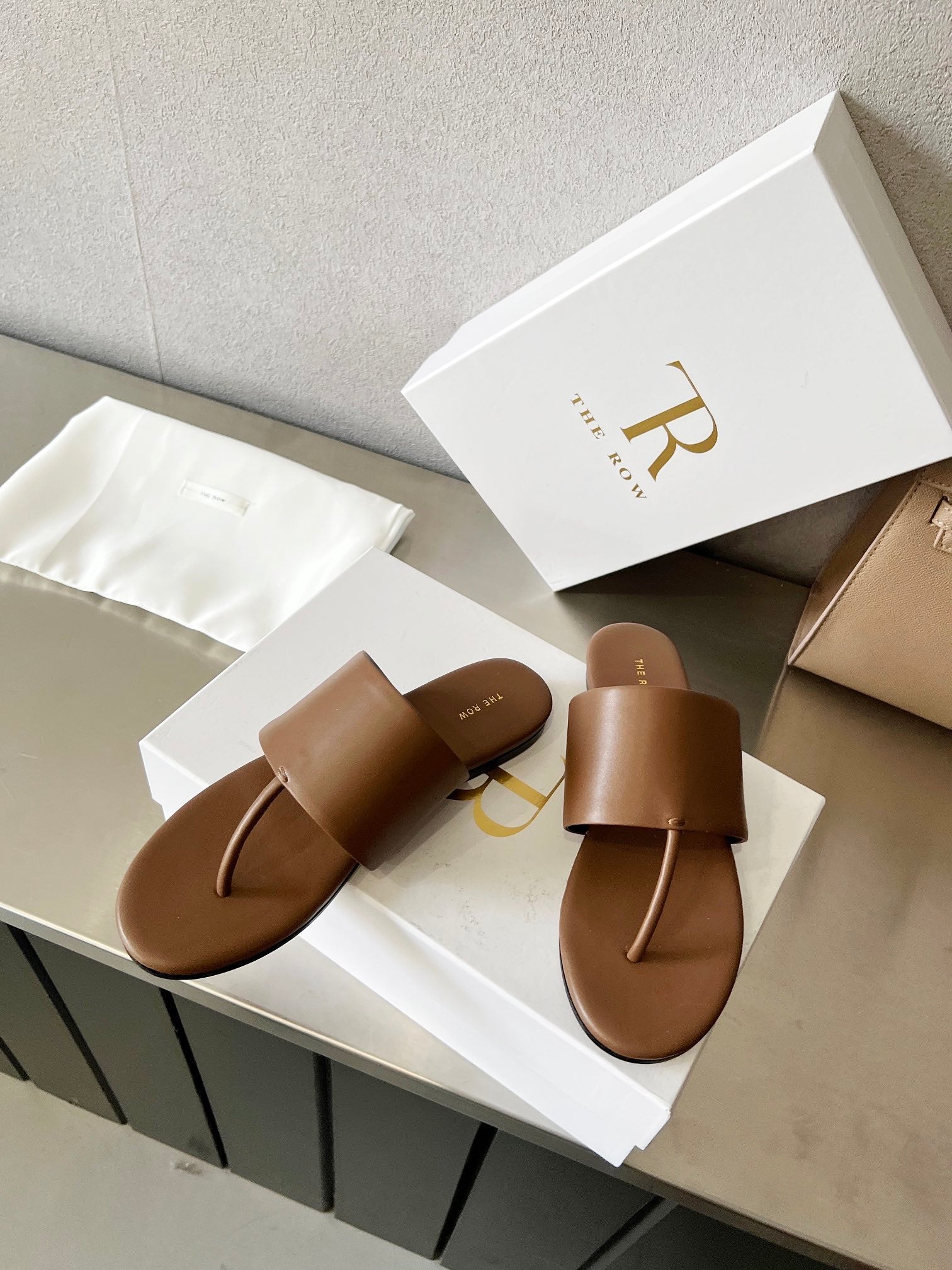 THE ROW 26S FLAT THONG SANDALS IN BROWN CALFSKIN