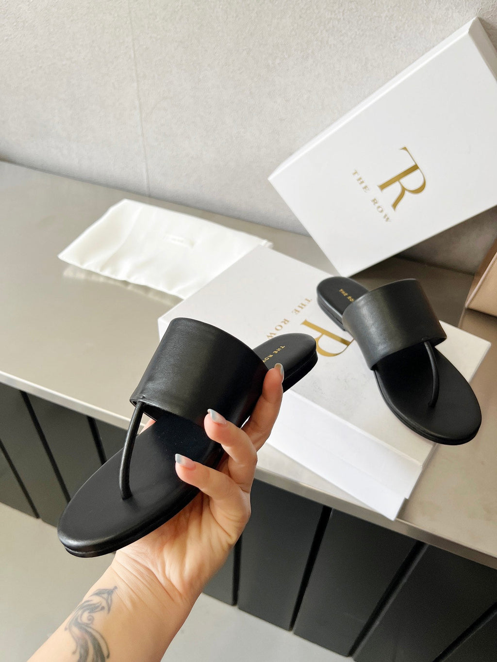 THE ROW 26S FLAT THONG SANDALS IN BLACK CALFSKIN