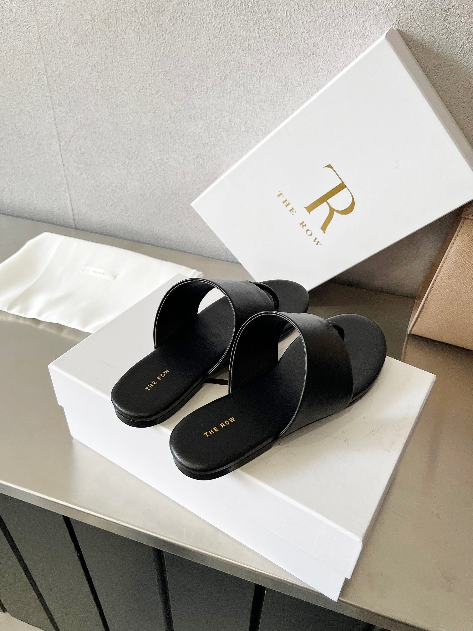 THE ROW 26S FLAT THONG SANDALS IN BLACK CALFSKIN