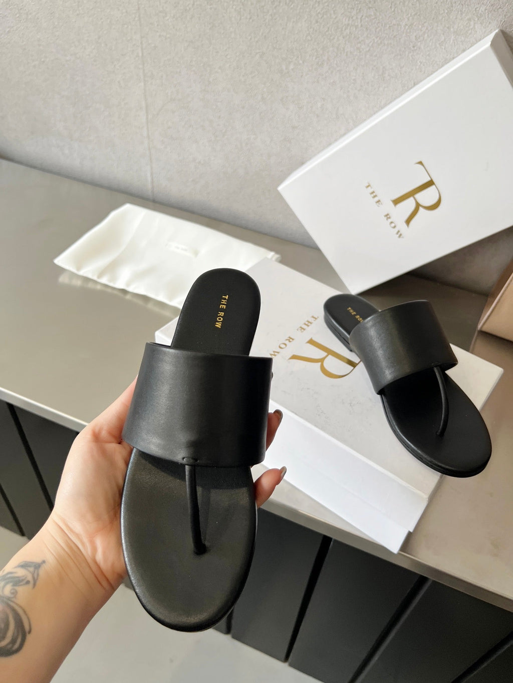 THE ROW 26S FLAT THONG SANDALS IN BLACK CALFSKIN