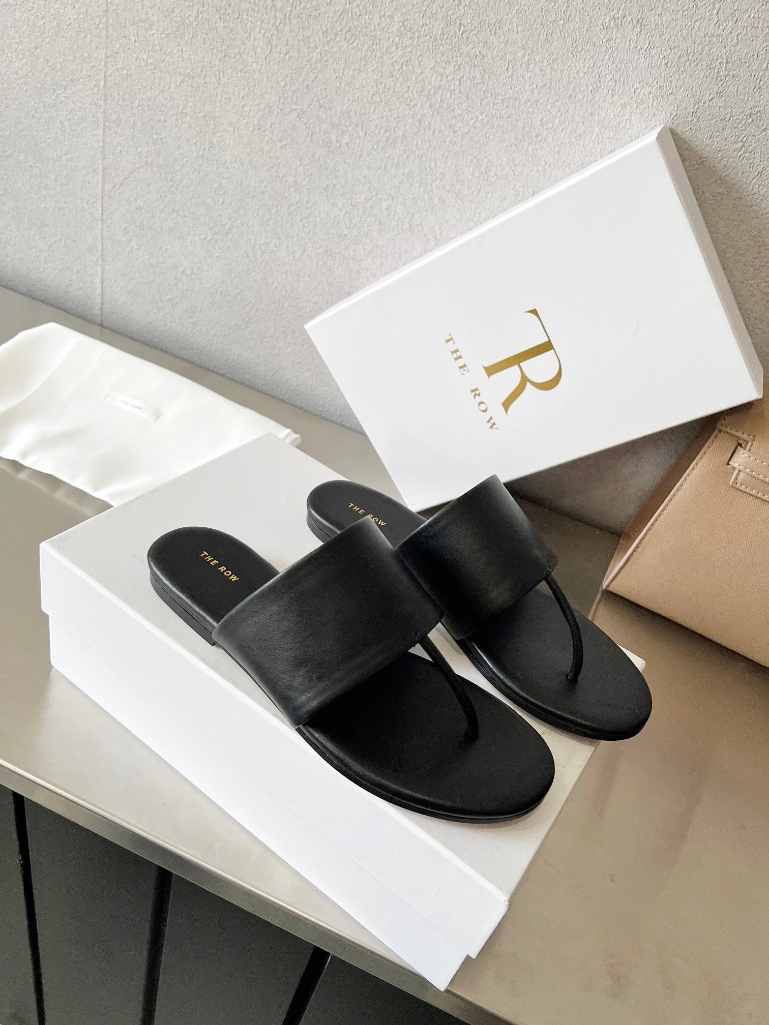 THE ROW 26S FLAT THONG SANDALS IN BLACK CALFSKIN