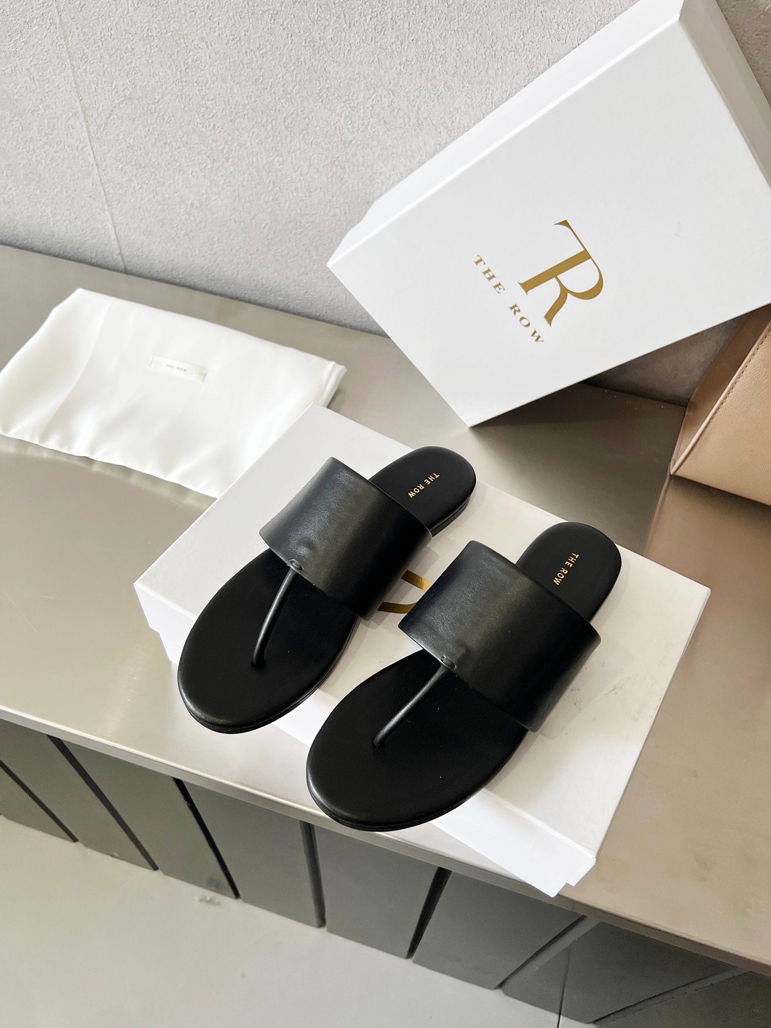 THE ROW 26S FLAT THONG SANDALS IN BLACK CALFSKIN