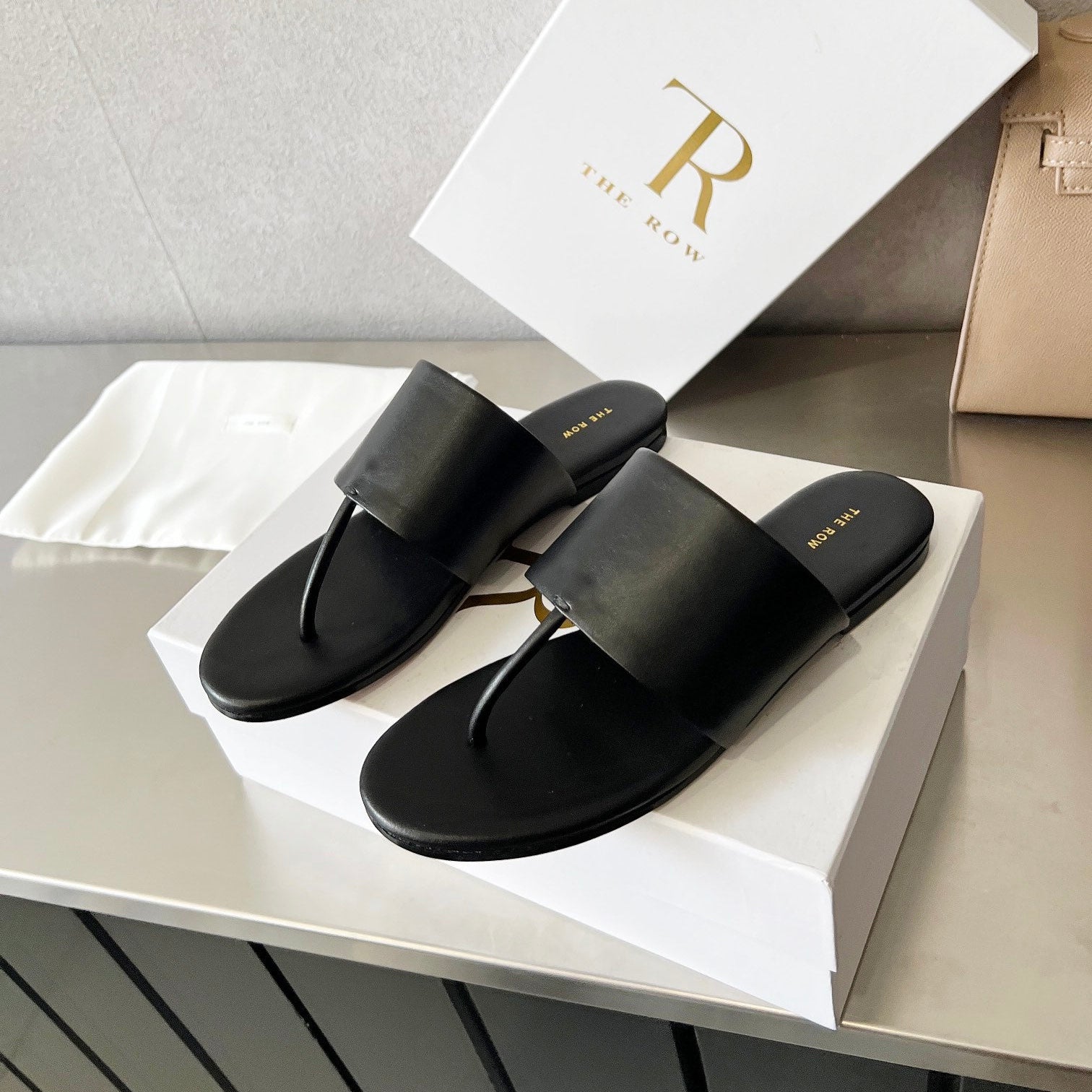 THE ROW 26S FLAT THONG SANDALS IN BLACK CALFSKIN