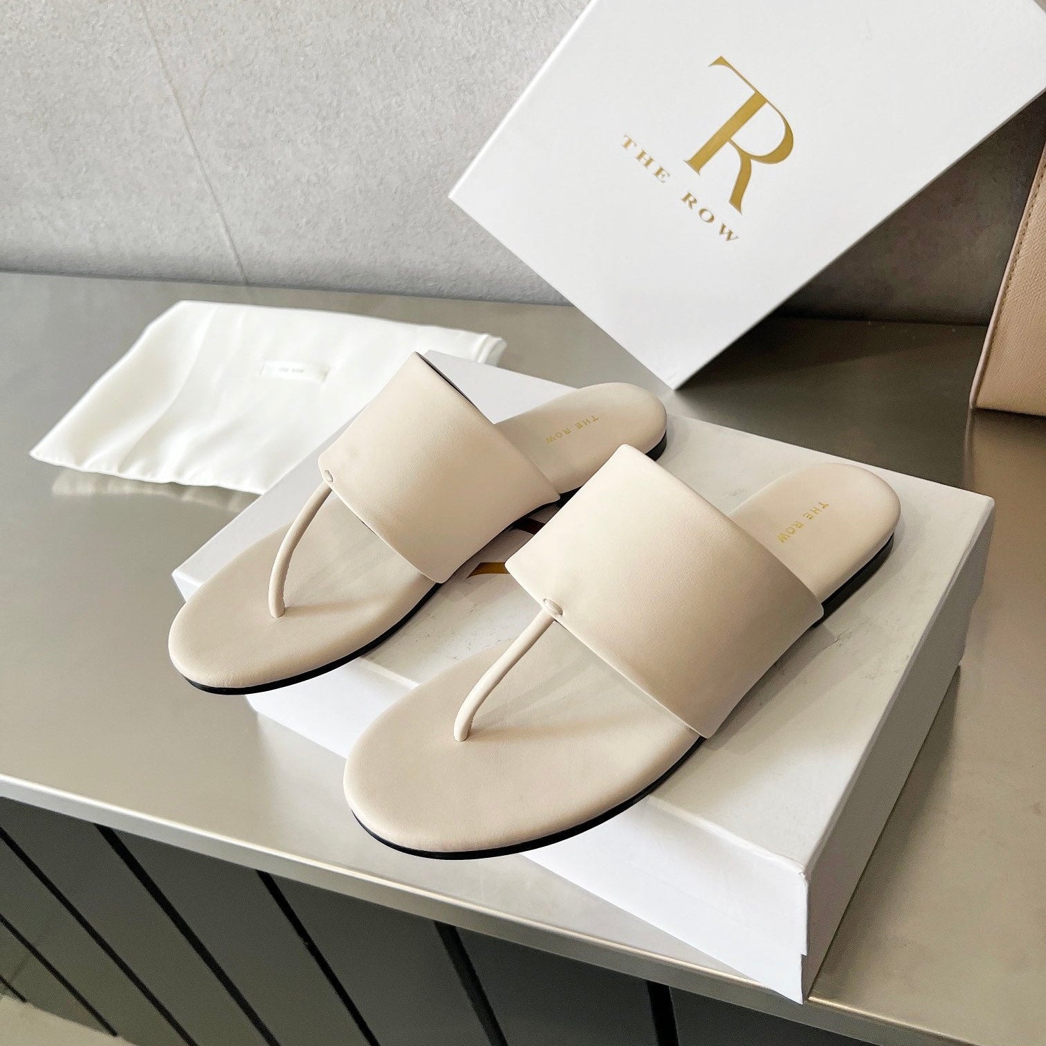 THE ROW 26S FLAT THONG SANDALS IN WHITE CALFSKIN