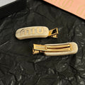 MIUMIU 26S LOGO HAIR CLIP IN IVORY MARBLE RESIN AND GOLD TONE METAL 625638