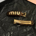 MIUMIU 26S LOGO HAIR CLIP IN TORTOISESHELL RESIN AND GOLD TONE METAL 625639