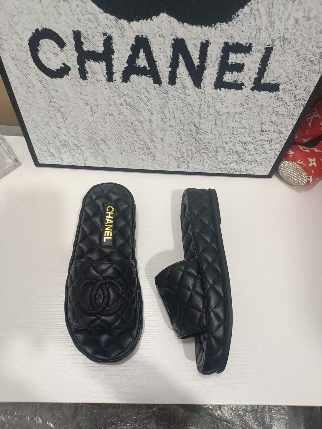 CHANEL 26S QUILTED SLIDE SANDALS IN BLACK CALFSKIN