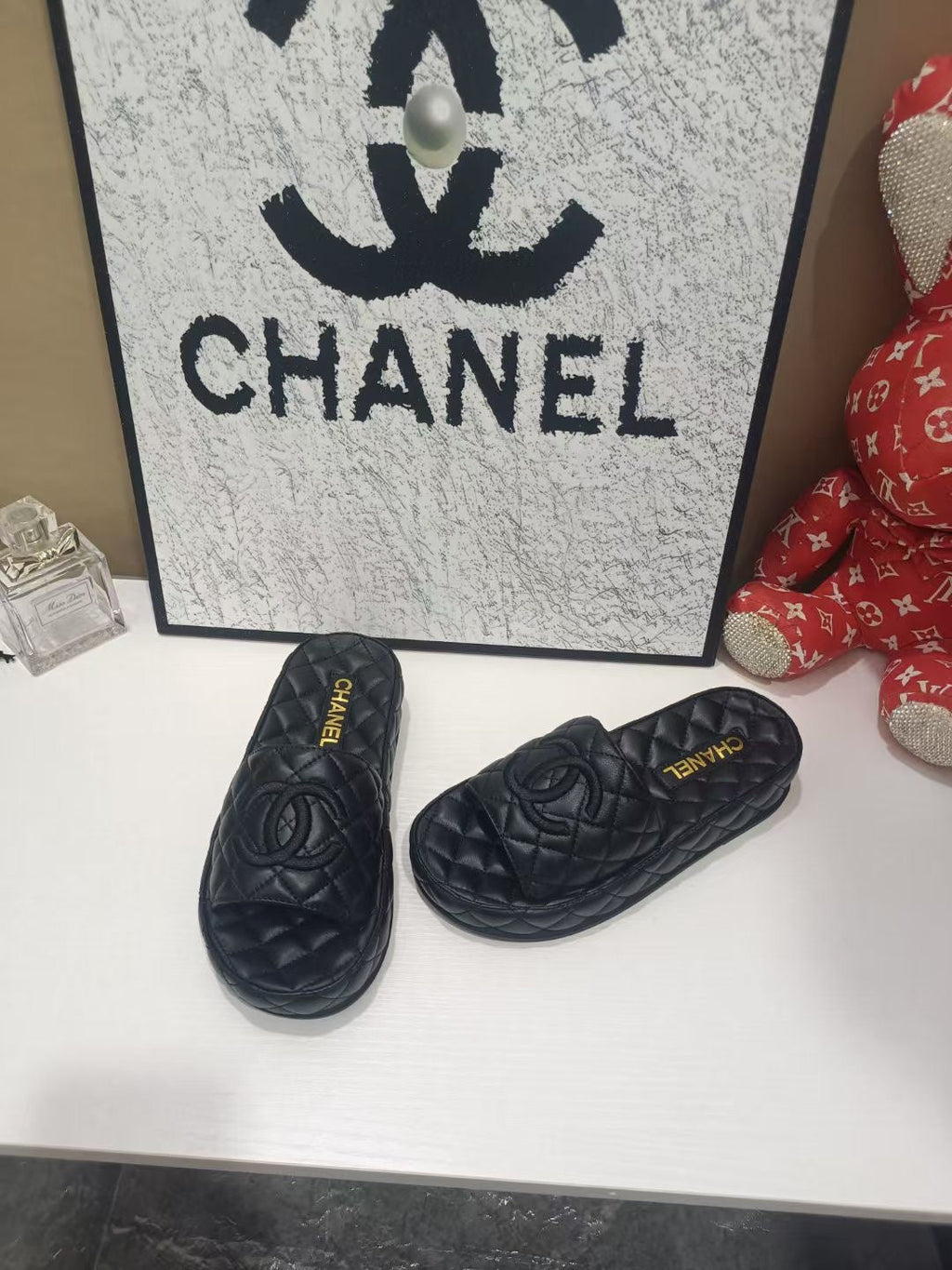 CHANEL 26S QUILTED SLIDE SANDALS IN BLACK CALFSKIN