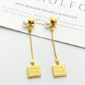 MIUMIU 26S PEARL BAR DROP LOGO EARRINGS IN GOLD TONE METAL 629846
