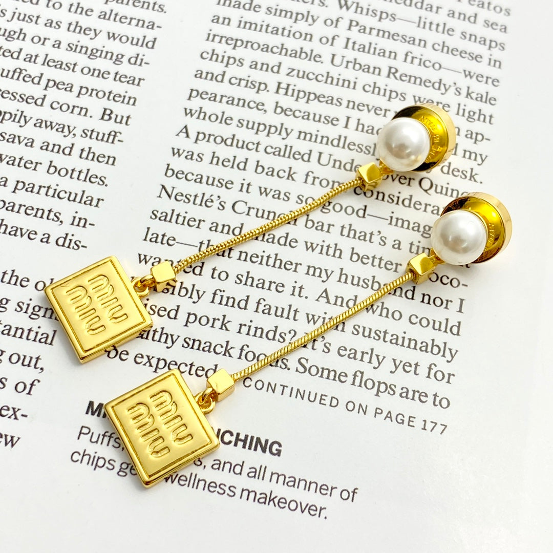 MIUMIU 26S PEARL BAR DROP LOGO EARRINGS IN GOLD TONE METAL 629846