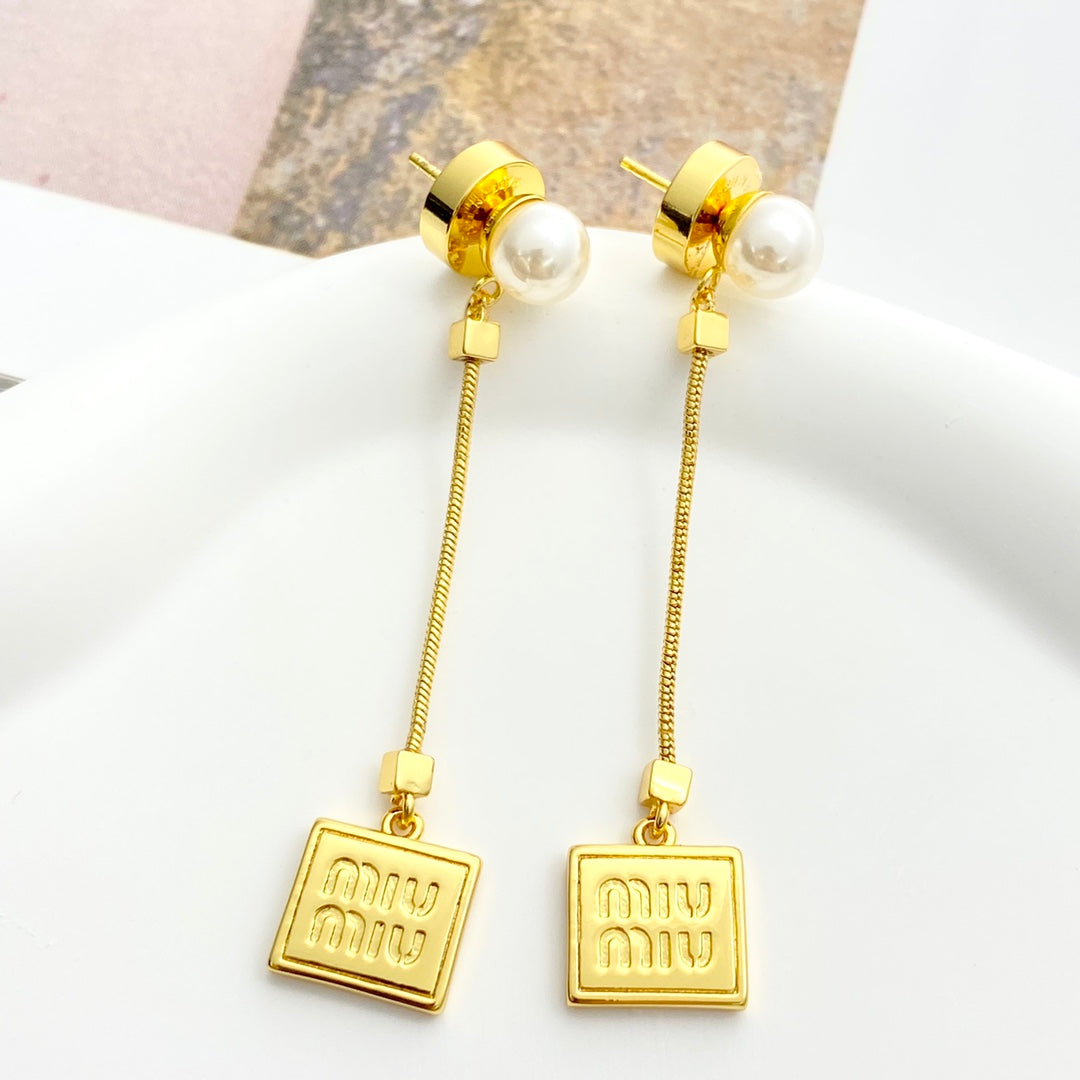 MIUMIU 26S PEARL BAR DROP LOGO EARRINGS IN GOLD TONE METAL 629846