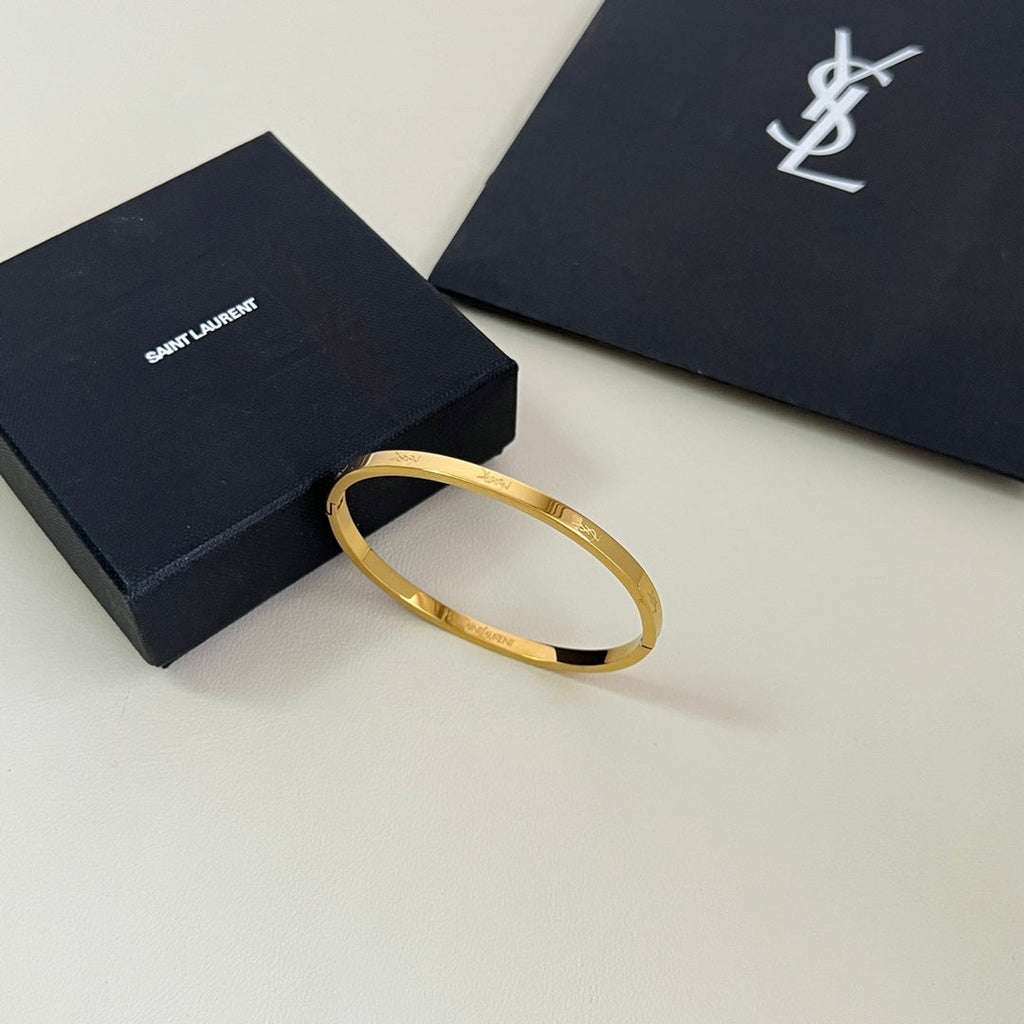 YSL 26S ENGRAVED LOGO BANGLE BRACELET IN GOLD TONE METAL 633272
