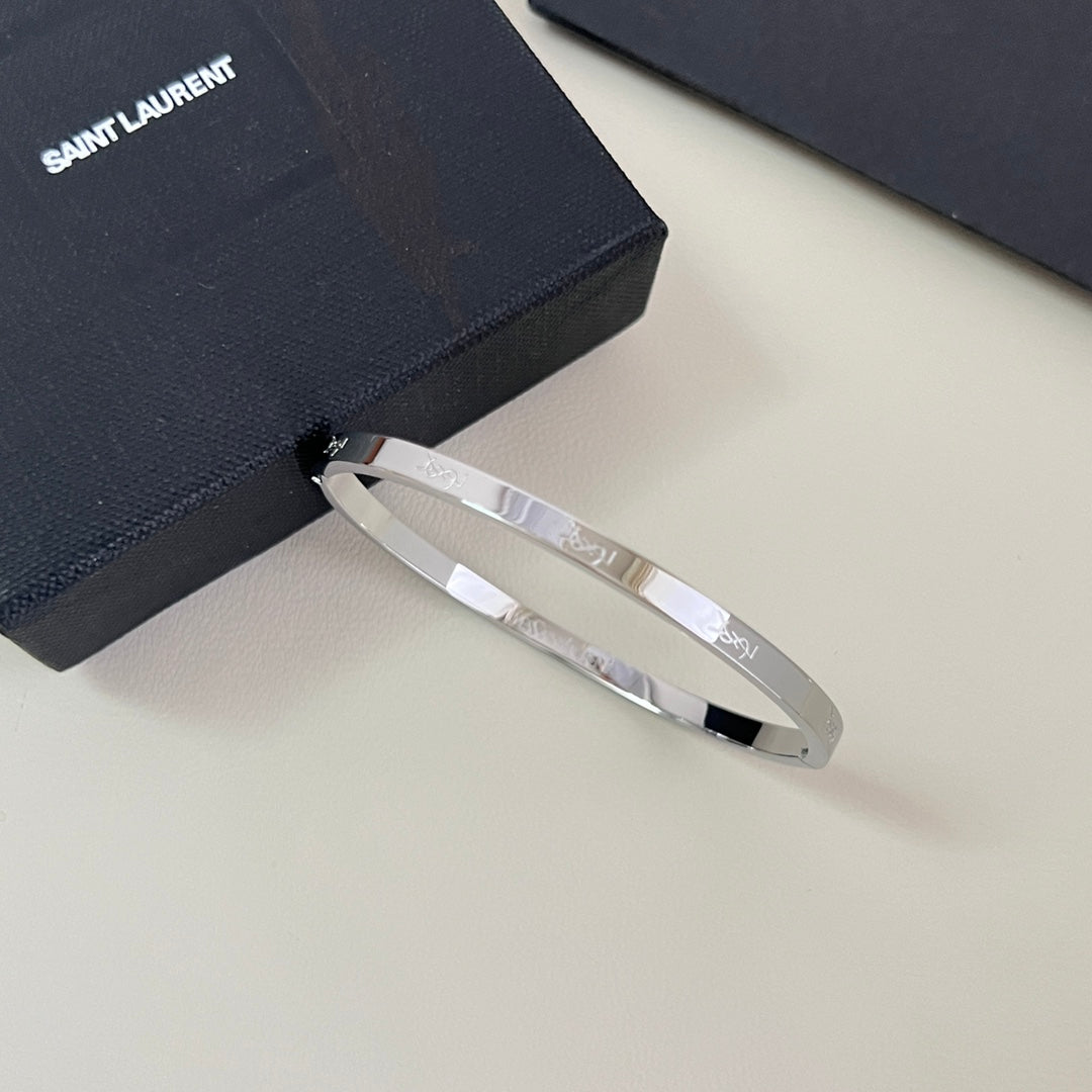 YSL 26S ENGRAVED LOGO BANGLE BRACELET IN SILVER TONE METAL 633273