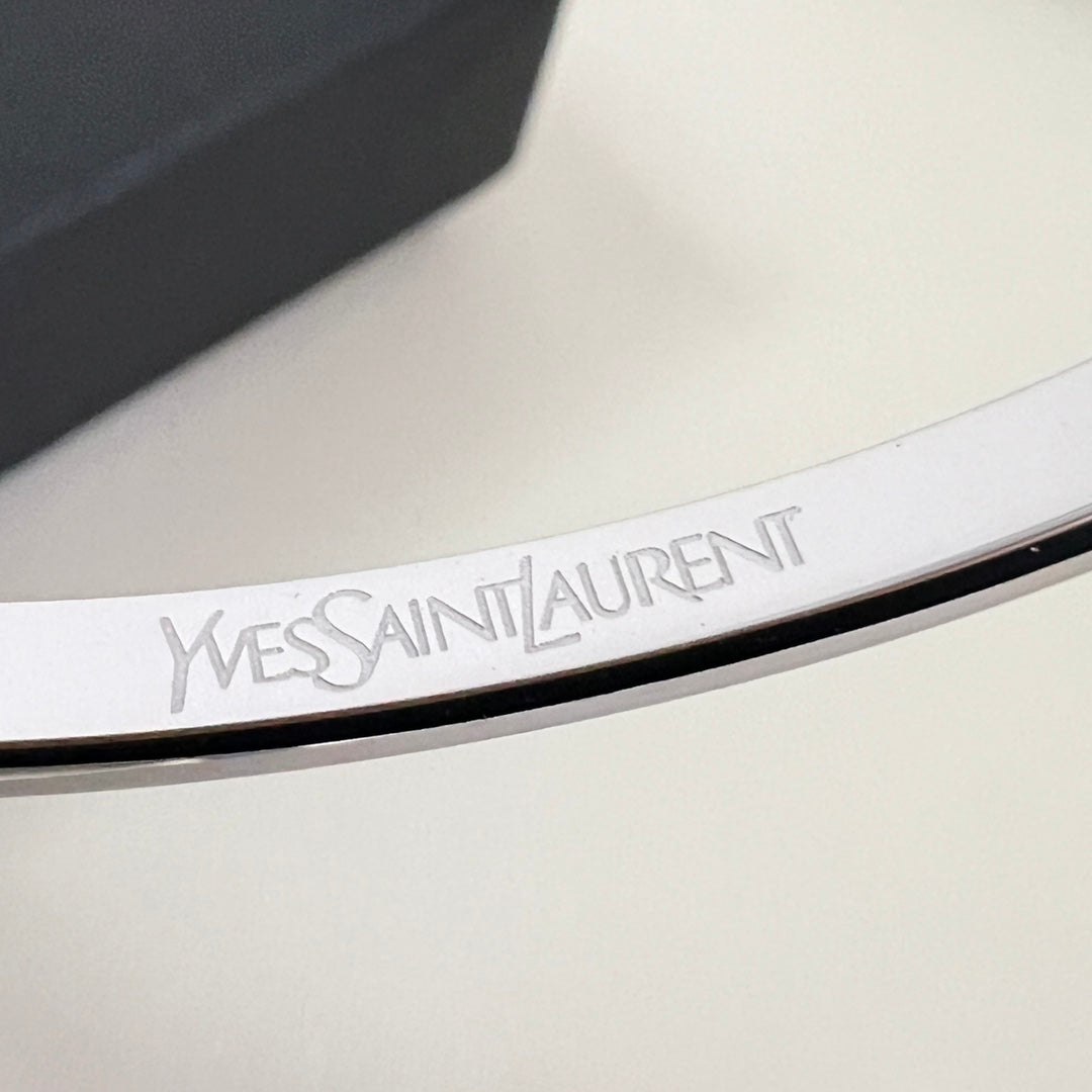 YSL 26S ENGRAVED LOGO BANGLE BRACELET IN SILVER TONE METAL 633273
