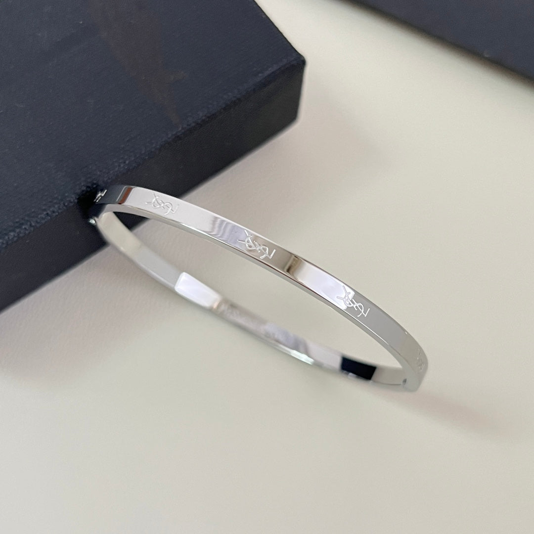 YSL 26S ENGRAVED LOGO BANGLE BRACELET IN SILVER TONE METAL 633273
