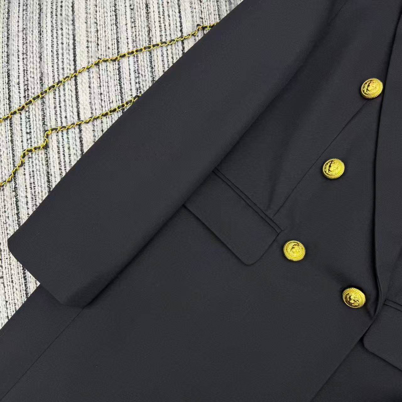LONG COAT IN BLACK WITH GOLD BUTTONS AND A SNAKE BROOCH
