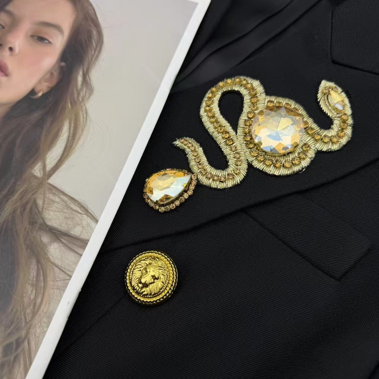 LONG COAT IN BLACK WITH GOLD BUTTONS AND A SNAKE BROOCH