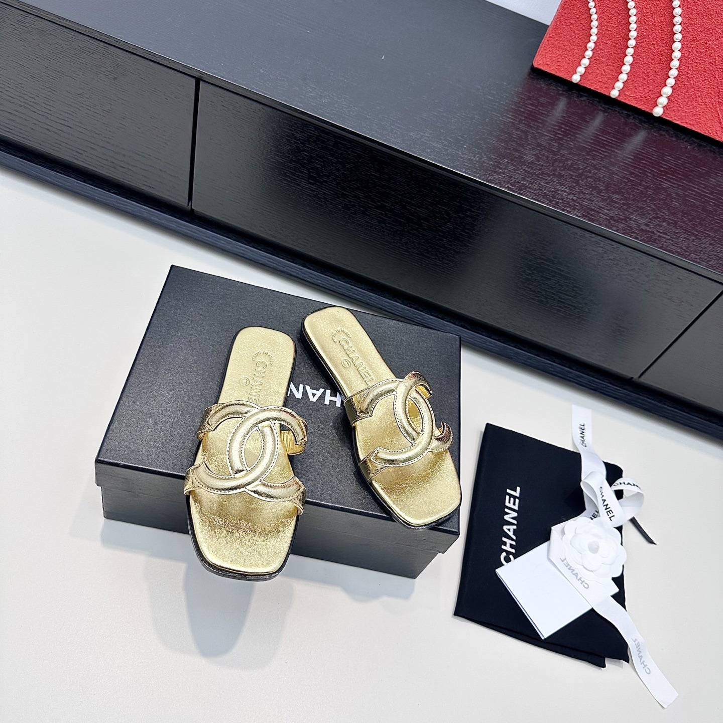CHANEL CC LOGO MULES IN GOLD METALLIC CALFSKIN