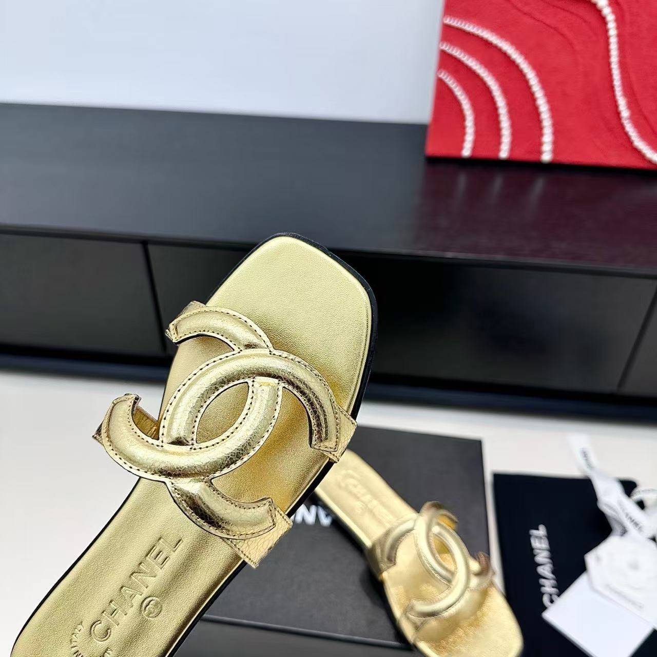 CHANEL CC LOGO MULES IN GOLD METALLIC CALFSKIN